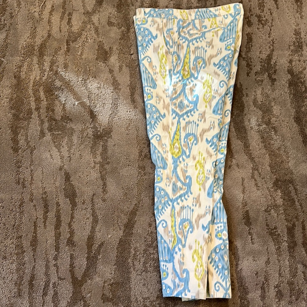 SoLo moda brand pants. Cream background with blue green and tan accents.